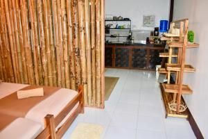 a room with a bed and a kitchen at Apartment El Nido in El Nido