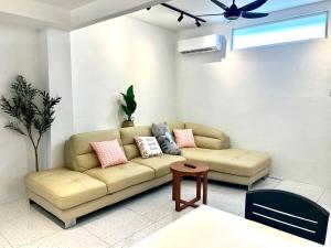 a living room with a couch and a ceiling fan at Casa for 8 ipoh Central Pet Allowed in Ipoh