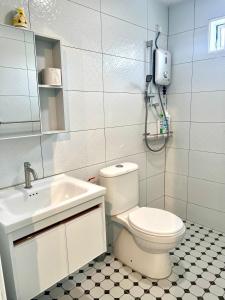 a white bathroom with a toilet and a sink at Casa for 8 ipoh Central Pet Allowed in Ipoh +24 photos