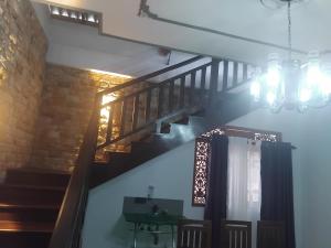 a staircase in a room with a chandelier at SAS Villa in Ahungalla +1 photo