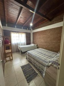 a bedroom with two beds and a window in it at M&M Cipolletti in Cipolletti