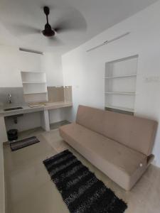 a living room with a couch and a desk at Ivory Suites in Kozhikode