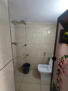 a bathroom with a toilet and a sink at Ivory Suites in Kozhikode