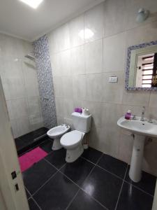 a bathroom with two toilets and a sink at M&M Cipolletti in Cipolletti +58 photos
