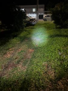 a yard with a light on the grass at night at Drica Pousada in São Gabriel