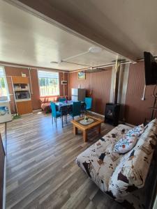 a living room with a couch and a table at Cabaña ByB in Dalcahue