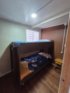 a bedroom with two bunk beds in a room at Cabaña ByB in Dalcahue