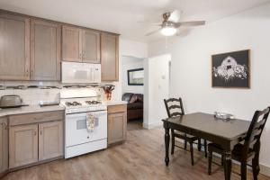 a kitchen and dining room with a table and a stove at Cherry Street Star in Bandera +24 photos