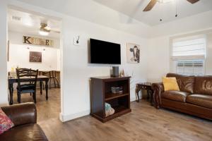 a living room with a couch and a flat screen tv at Cherry Street Star in Bandera