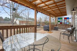 a patio with a glass table and chairs on a deck at Cherry Street Star in Bandera