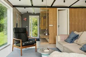a living room with a couch and a chair at Fjord-Close Cottage With Beautiful View in Hemmet