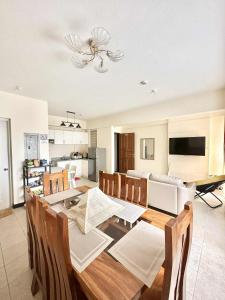 a dining room and kitchen with a table and chairs at THE PRECIOUS TIME LOUNGe in Davao City