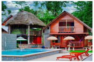 a resort with a swimming pool and a house at QUINTA PRIMAVERA - Hostería Campestre in Nueva Loja