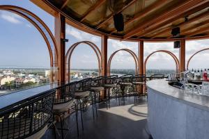 a bar on the top of a building with windows at Hotel Royal Hoi An Danang, The Legacy Riverfront Resort & Spa in Hoi An +96 photos