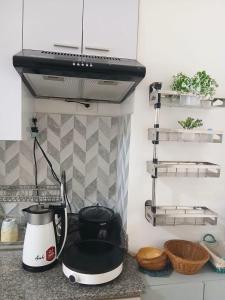 a kitchen counter with a tea kettle and a blender at Haute Haven - 1br with Balcony in Manila