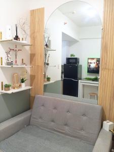 a living room with a couch and a kitchen at Haute Haven - 1br with Balcony in Manila
