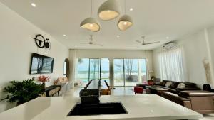a living room with a couch and a table at Beach Villas Phan Thiêt in Bình Sum
