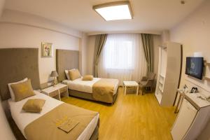 Postel nebo postele na pokoji v ubytování Bilge Suite Hotel
