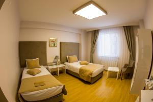 Postel nebo postele na pokoji v ubytování Bilge Suite Hotel