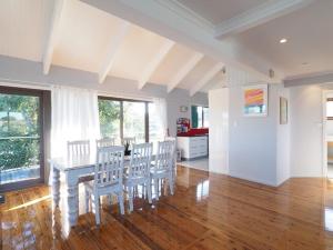 a kitchen and dining room with a table and chairs at Callala Beach Shack - Pet Friendly in Callala Beach