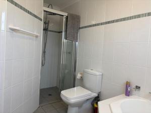 a bathroom with a shower and a toilet and a sink at Callala Beach Shack - Pet Friendly in Callala Beach +14 photos