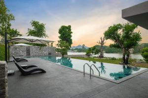 a swimming pool with a view of a river at Mont Du Kwai Resort in Ban Yang (2)