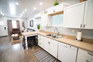 a kitchen with white cabinets and a sink at Aunt Beans Guest Suite in Kanab