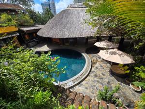 an overhead view of a resort with a pool and umbrella at MissBamboo Hotel Nha Trang in Nha Trang