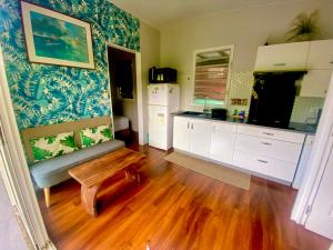 a living room with a couch and a table at Tiny house with pool near Vaiava beach in Punaauia +22 photos