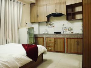 a kitchen with a bed and a counter top at The Abode in Kathmandu