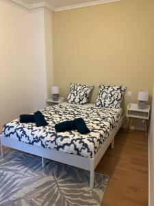 a bed in a room with two tables and two lamps at L Écrin d or in Montluçon