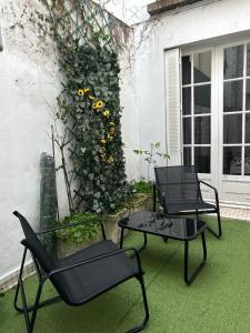 two chairs and a table on a patio at L Écrin d or in Montluçon