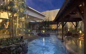 a building with a swimming pool in front of a building at Hotel Daiki in Osaka