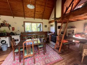a kitchen with a table and chairs and a ladder at The Innlet, Country Apartments and Cottages in Collingwood