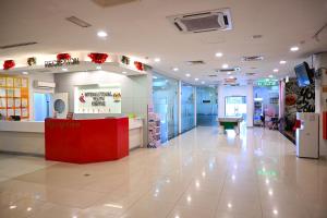 a hospital lobby with a red counter in the middle at Pusat Belia Antarabangsa in Kuala Lumpur