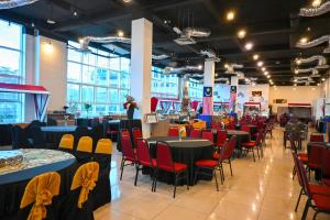 a banquet hall with tables and chairs in a building at Pusat Belia Antarabangsa in Kuala Lumpur