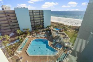 an aerial view of a hotel with a pool and the beach at Renovated Beach Front Condo TOG 310 in Panama City Beach