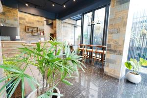 a lobby with potted plants and a table and chairs at 吾庭文旅電梯民宿 WuTing Stay in Hualien City