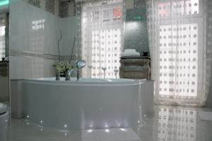 a white tub in a bathroom with a window at Apartamenty Boutique in Ustka
