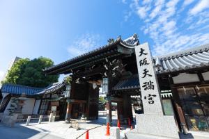 a building with a sign in front of it at Hotel Daiki in Osaka