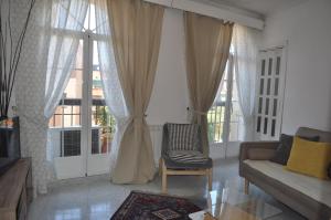 a living room with a couch and a window at Cuatro Camino Apartment with elevator in Madrid