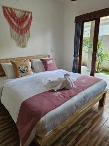 a bedroom with a large bed with purple sheets at Villa Casa Delta Canggu in Canggu +39 photos