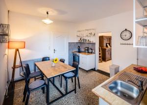 a kitchen and living room with a table and chairs at Seeblick Bed & Breakfast in Lassahn