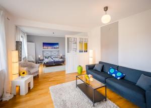 a living room with a blue couch and a table at Seeblick Bed & Breakfast in Lassahn