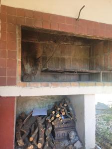 a brick oven with a pile of wood in it at La vuelta y el vaso in Playa Verde
