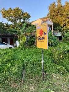 a sign in the grass in front of a house at Friend Guesthouse , Kho Lanta in Ko Klang +50 photos