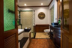 a bathroom with a shower and a toilet and a sink at Villa Sirilanna Hotel in Chiang Mai