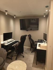 an office with two desks and two chairs and a monitor at DK hotel in Incheon