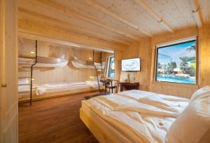 a bedroom with a bed in a wooden room at Hotel Victory Therme Erding in Erding