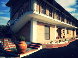 a building with stairs and a balcony on it at B&B MULA Germaneto in Santa Maria +23 photos